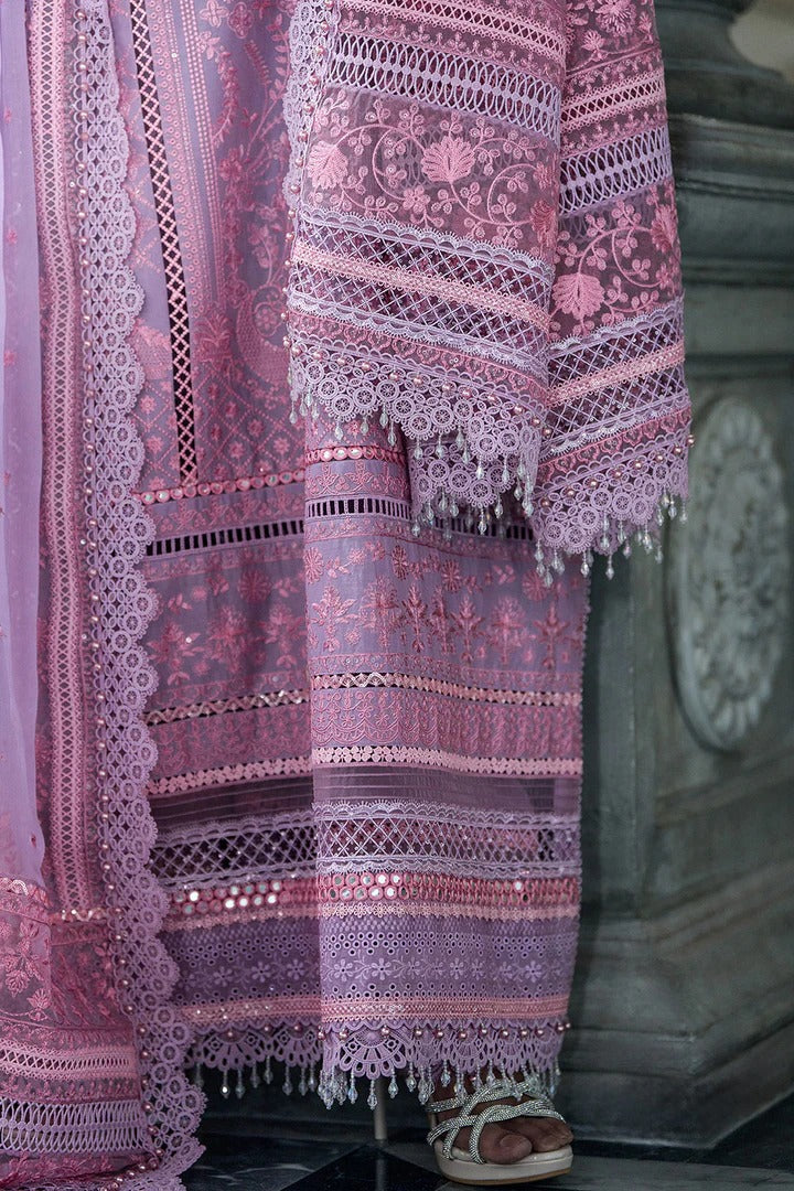 Decorative pink and purple fabric with intricate patterns and tassels.