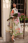 Woman in a floral dress standing on steps with plants in the background