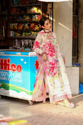 Woman in a floral dress walking past an ice cream cart with a colorful sign.