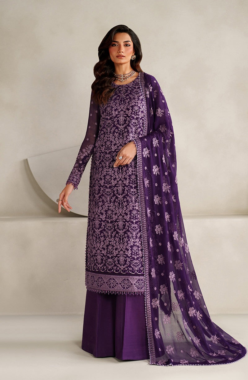 Woman wearing a purple embroidered outfit with a matching dupatta against a neutral background