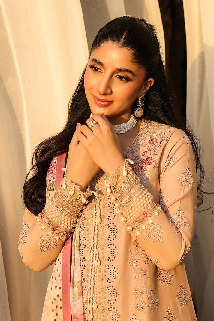Woman in traditional attire with floral patterns against a neutral background