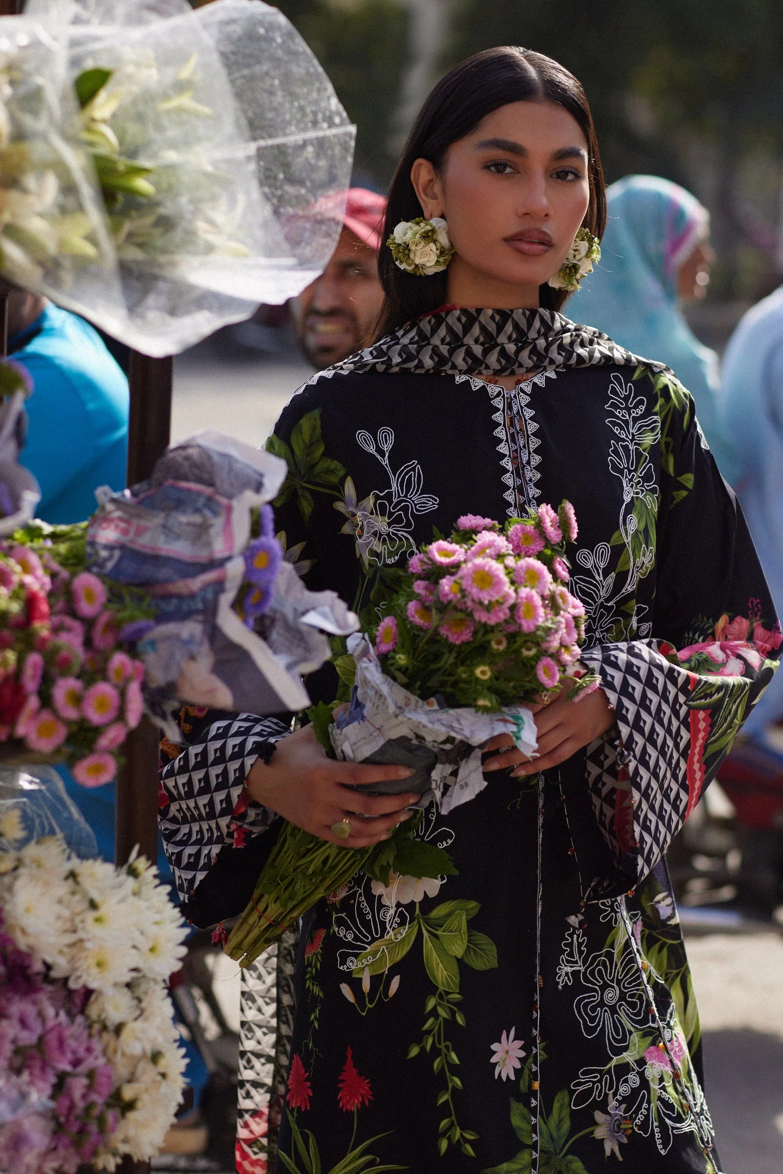 Woman holding flowers in a market setting