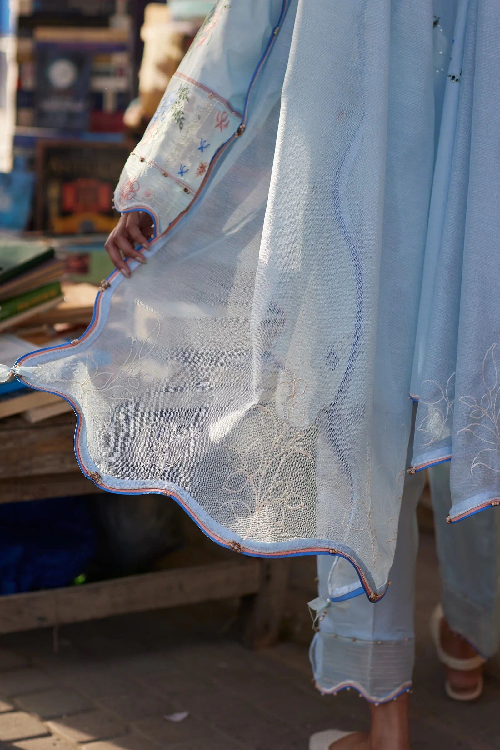 Light blue embroidered traditional outfit with a blurred background