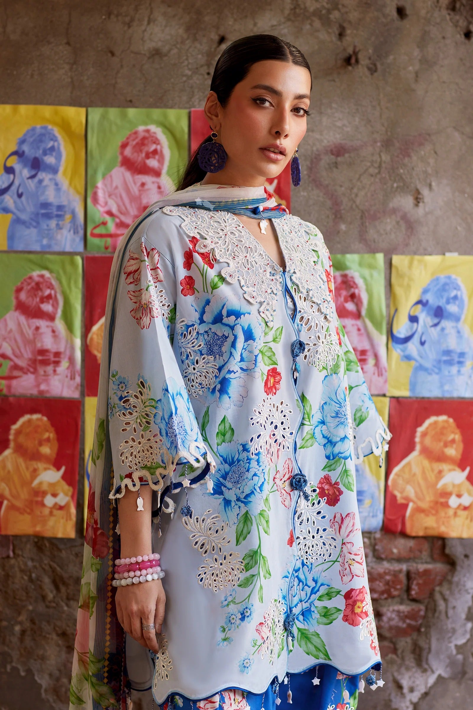 Woman wearing a colorful floral dress with a patterned background