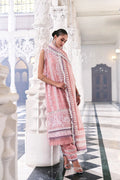 Woman in a pink traditional outfit with a matching dupatta in an ornate hall.