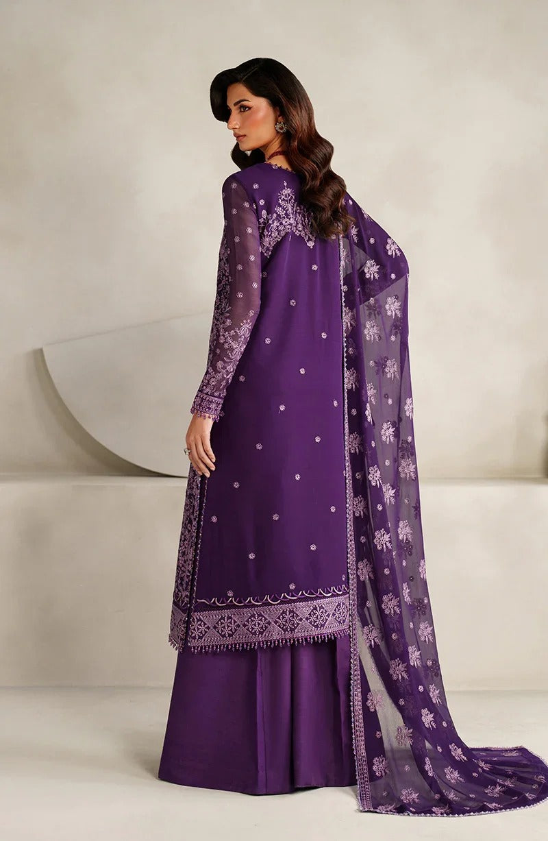Woman wearing a purple traditional outfit with a matching dupatta on a white background