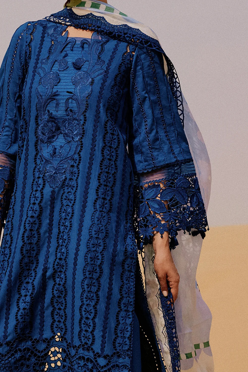 Blue embroidered dress with intricate patterns on a plain background