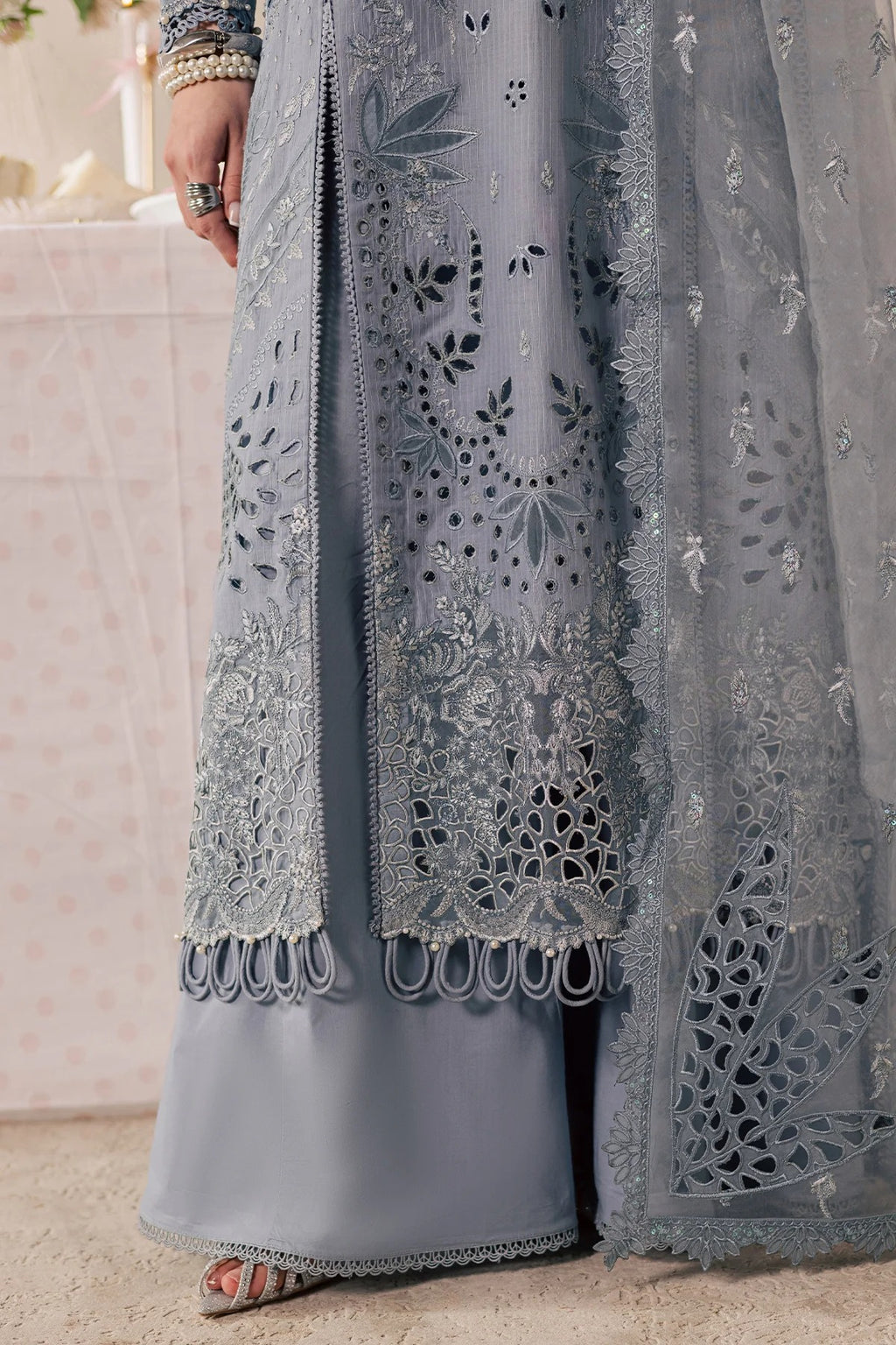 Close-up of a gray embroidered garment with intricate patterns.