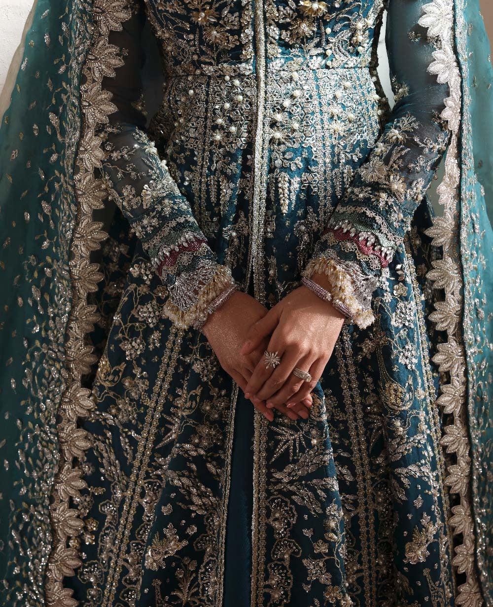 Close-up of a person wearing an ornate, patterned garment with intricate detailing.