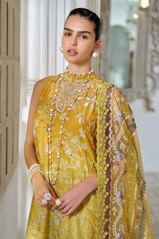 Woman wearing a yellow embroidered traditional outfit with a matching dupatta.
