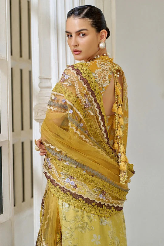 Woman wearing a yellow embroidered saree in an indoor setting