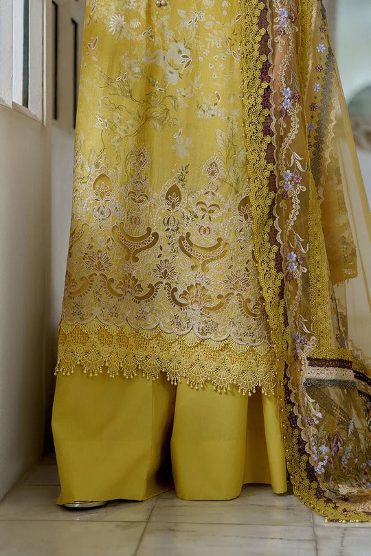 Yellow embroidered traditional outfit with a matching dupatta on a tiled floor.