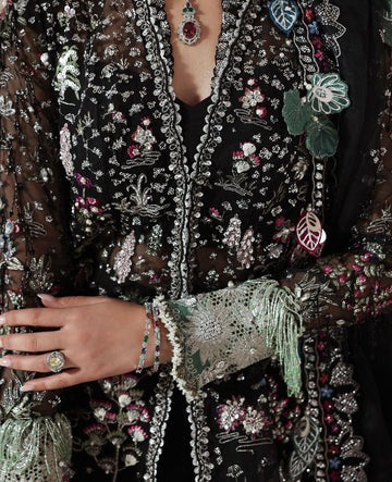 Close-up of an intricately embroidered garment with floral patterns and embellishments.