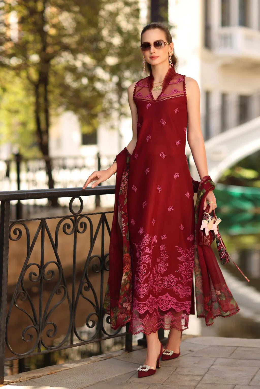 Woman in a red dress standing outdoors with a blurred background