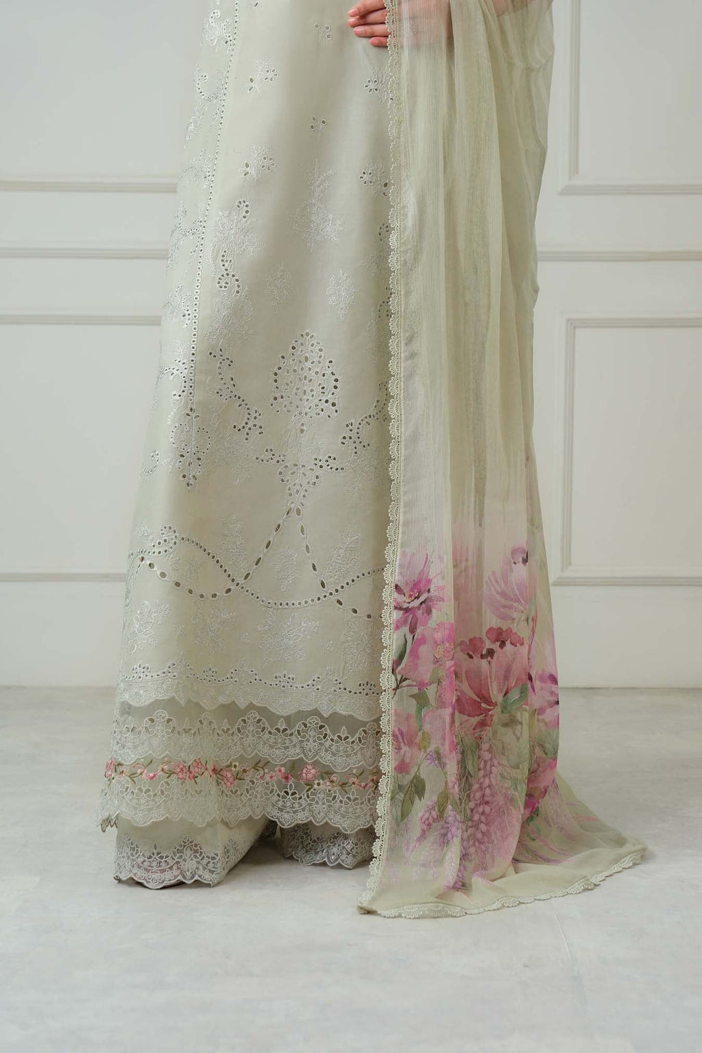 Sheer fabric with floral design and lace details on a white background