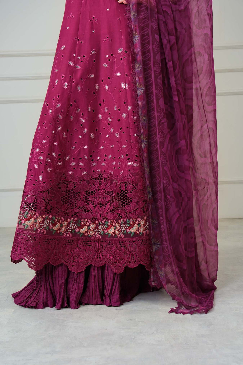 Magenta traditional outfit with floral patterns on a white background