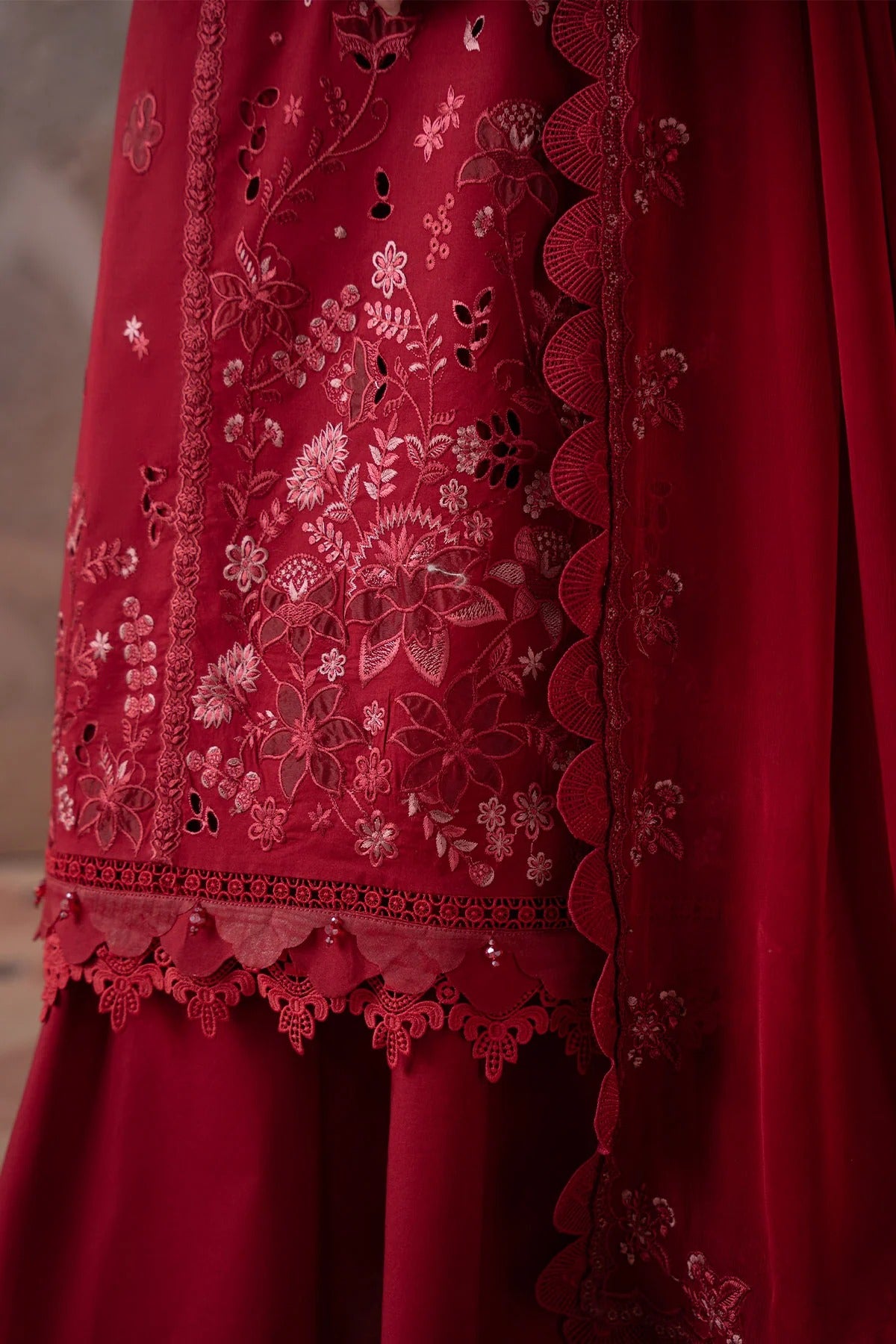 Red embroidered garment with intricate patterns on a plain background