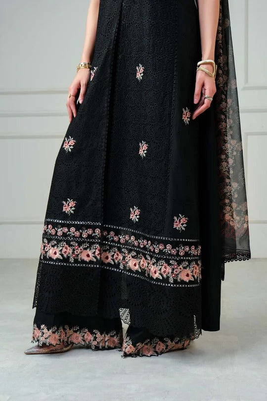 Black embroidered dress with floral patterns on a plain background