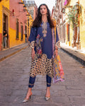 Woman in traditional outfit walking down a colorful street