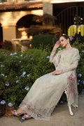 Woman in a traditional outfit sitting outdoors with a blurred background