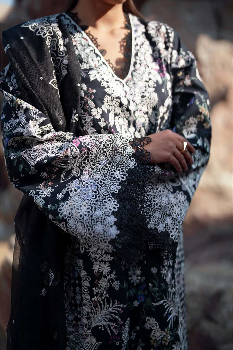 Black dress with white floral embroidery on a blurred background