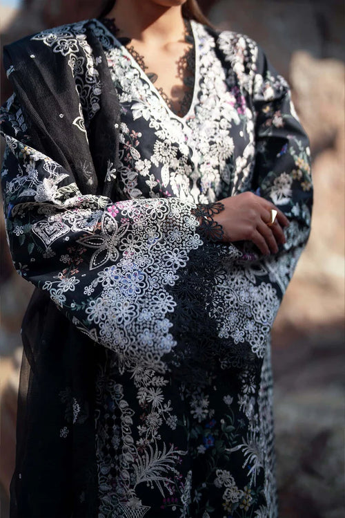 Black dress with white floral embroidery on a blurred background