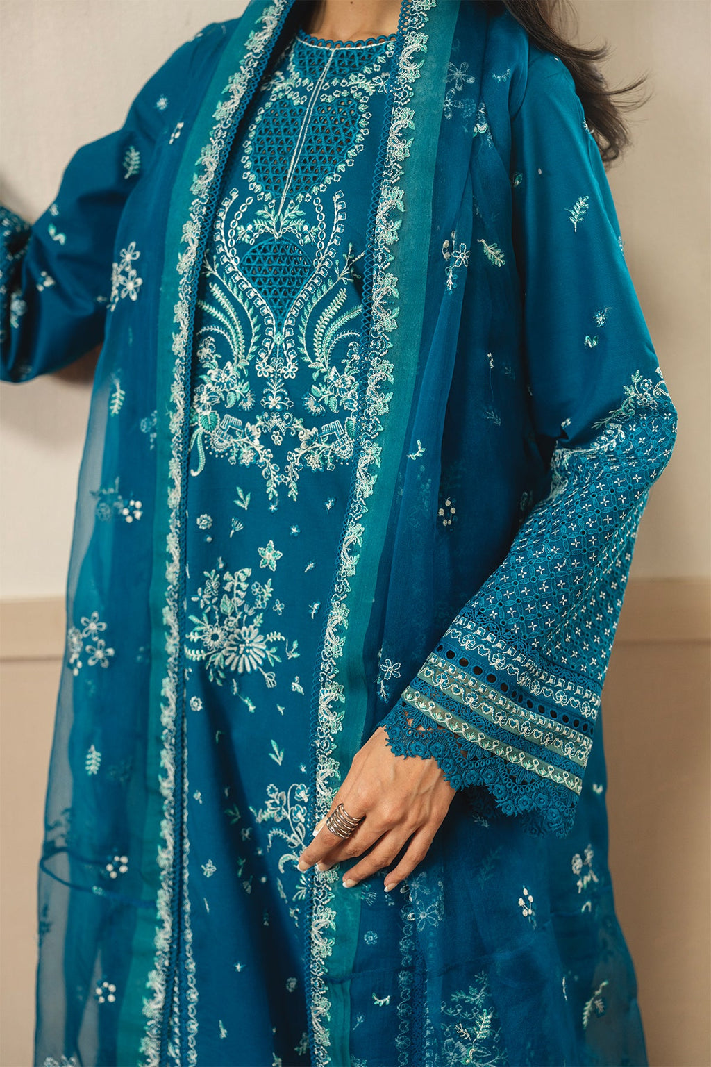 Teal embroidered traditional outfit with matching dupatta on a neutral background